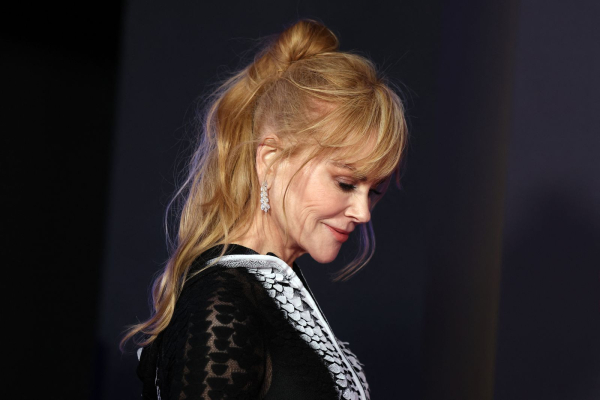 Nicole Kidman poses in a ponytailtwist hairstyle and a black lace outfit.